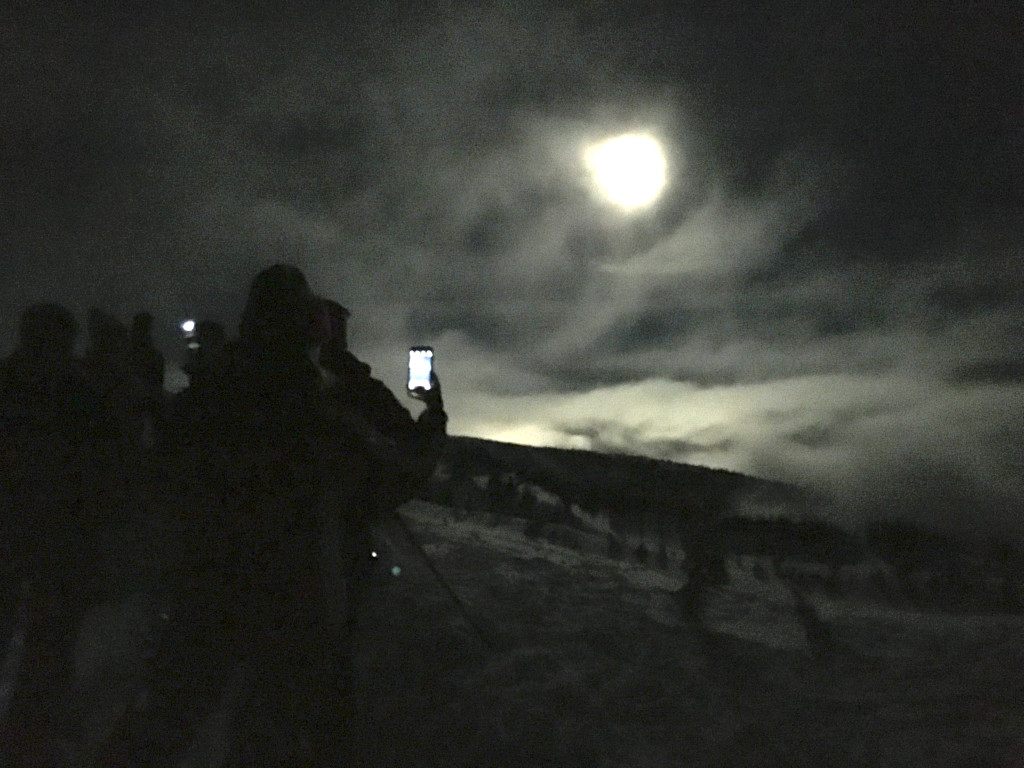 moonlight snowshoe cellphone crowd